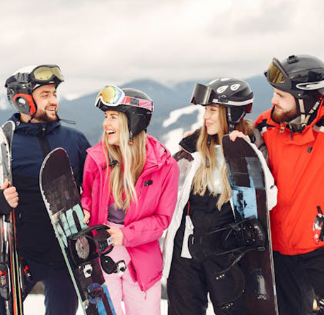 Snowboarder performing a trick against a snowy Mt. Buller backdrop.